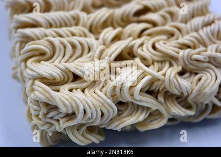 Quick cooking product, food, vermicelli, thin noodles in dry form is located on a white background. Stock Photo