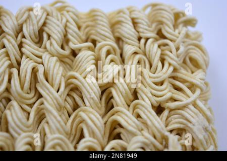 Quick cooking product, food, vermicelli, thin noodles in dry form is located on a white background. Stock Photo