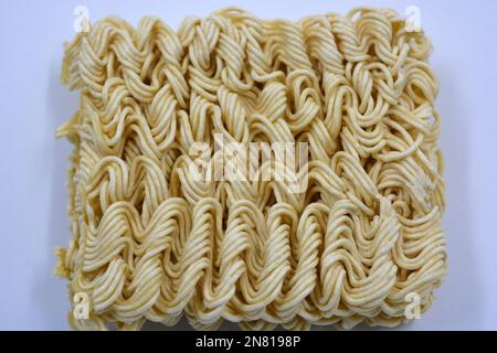 Quick cooking product, food, vermicelli, thin noodles in dry form is located on a white background. Stock Photo