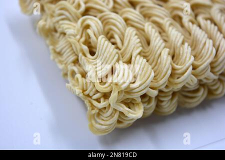 Quick cooking product, food, vermicelli, thin noodles in dry form is located on a white background. Stock Photo