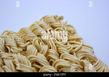 Quick cooking product, food, vermicelli, thin noodles in dry form is located on a white background. Stock Photo