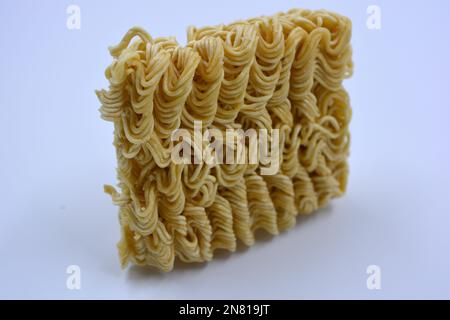 Quick cooking product, food, vermicelli, thin noodles in dry form is located on a white background. Stock Photo
