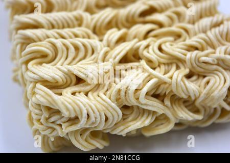 Quick cooking product, food, vermicelli, thin noodles in dry form is located on a white background. Stock Photo