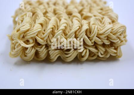 Quick cooking product, food, vermicelli, thin noodles in dry form is located on a white background. Stock Photo