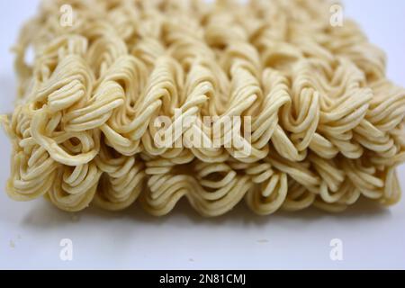 Quick cooking product, food, vermicelli, thin noodles in dry form is located on a white background. Stock Photo