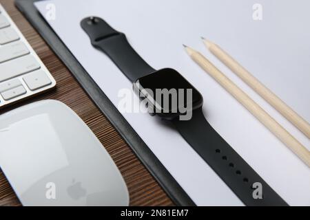 MYKOLAIV, UKRAINE - JULY 20, 2020: Composition with different Apple gadgets on wooden table Stock Photo