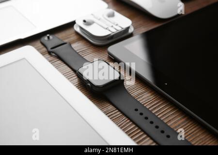 MYKOLAIV, UKRAINE - JULY 20, 2020: Composition with different Apple gadgets on wooden table Stock Photo