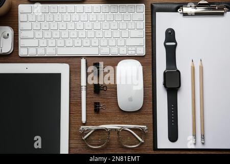 MYKOLAIV, UKRAINE - JULY 20, 2020: Flat lay composition with different Apple gadgets on wooden table Stock Photo