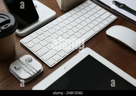 MYKOLAIV, UKRAINE - JULY 20, 2020: Composition with iPhone 11 and different Apple gadgets on wooden table Stock Photo