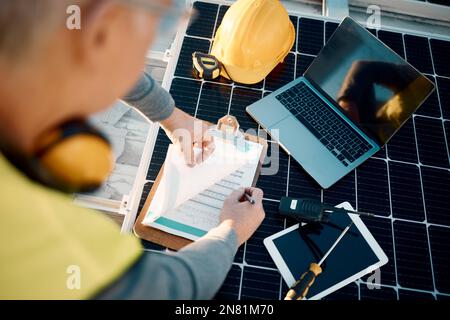 Solar panels, planning and engineering hands with technology, checklist or insurance for installation. Energy saving, electricity and power technician Stock Photo