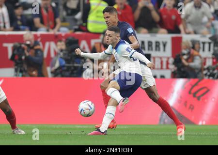 Phil Foden of England (L) and Raphael Varane of France (R) in action during the FIFA World Cup Qatar 2022 Quarter finals match between England and France at Al Bayt Stadium. Final score: England 1:2 France. Stock Photo