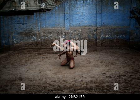 Pakistani Kushti wrestlers fight during their daily training, in Lahore ...