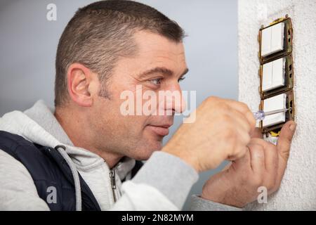 man doing electrical repairs at home Stock Photo