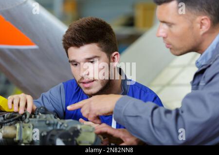 experienced auto mechanic scanning and interpreting engine Stock Photo