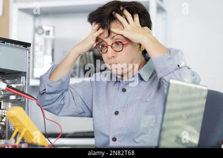 portrait of engineer stress holding his head Stock Photo