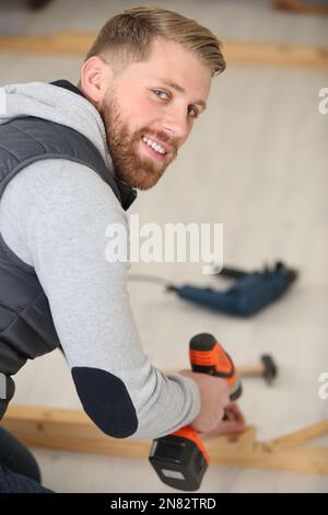 carpenter using cordless screwdriver Stock Photo