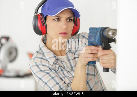 serious woman with a drill screwdriver Stock Photo