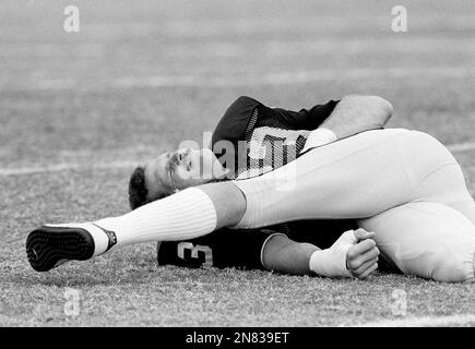 Los Angeles Raiders linebacker Ted Hendricks stretches during an exercise  period at a Raiders practice session in Tampa, Florida on Jan. 18, 1984, as  the team prepares for Sunday's Super Bowl XVIII