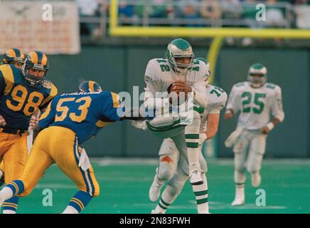 Philadelphia Eagles quarterback Randall Cunningham is tackled by New York  Giants' Lawrence Taylor as he ran for a three yard gain in the fourth  quarter of game at Veterans Stadium in Philadelphia