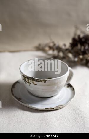Handmade empty craft ceramic on  textile background. Stock Photo