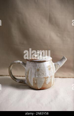 Handmade empty craft ceramic on  textile background. Stock Photo