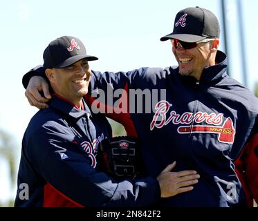 Atlanta Braves 1995 World Series champion teammates Chipper Jones, left,  and David Justice laugh before the third full squad spring training  baseball workout, Monday, Feb. 27, 2012, in Lake Buena Vista, Fla.