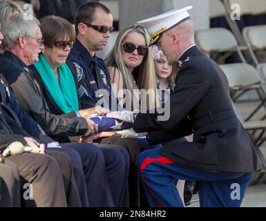 Regina Crain, the widow of Riverside Police officer Michael Crain, left ...