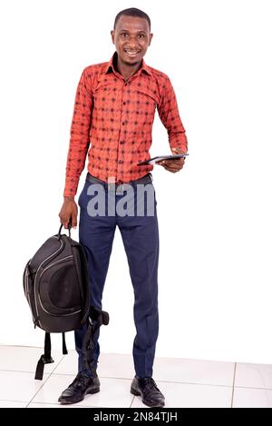 young man holding backpack and digital tablet while smiling at camera. Stock Photo
