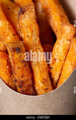 Sweet potato fries in a takeaway card container box. Disposable recycling sustainable plastic free takeaway packaging Stock Photo