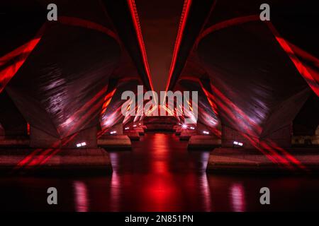 Red lights under a modern concrete bridge Stock Photo