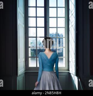 woman looking through window Stock Photo