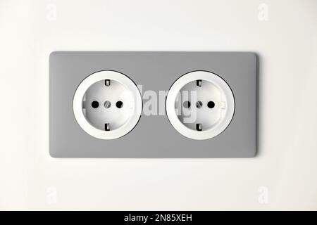 Stylish gray Electric Outlet. Power outlet on the wall. Euro type electric outlet on wall. Stock Photo