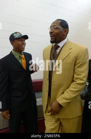 Ray Lewis III, center, shares a laugh with his father, former Baltimore  Ravens linebacker Ray Lewis Jr., left, and his mother, Tatyana McCall,  during a national signing day ceremony in the Lake