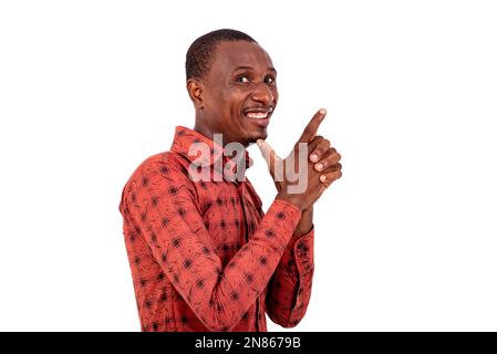 portrait of a handsome young businessman pointing fingers aside while smiling at the camera. Stock Photo