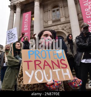 A protester holds a placard during the Trans march.Spectators