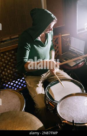 Drummer recording drums in music studio Stock Photo