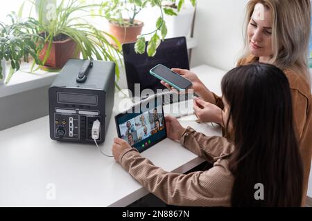 The inverter generator charges the power bank battery Stock Photo