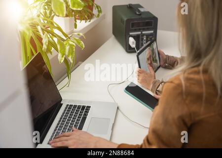 The inverter generator charges the power bank battery Stock Photo