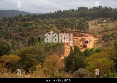 Karatu, Tanzania - October 16th, 2022: A mud brick factory in the jungle near Karatu, Tanzania. Stock Photo