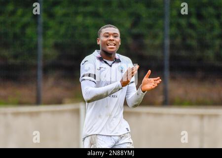 Swansea, Wales. 4 February 2023. Richard Faakye of Swansea City holds off  the challenge from Jack Howland of Millwall during the Professional  Development League game between Swansea City Under 18 and Millwall