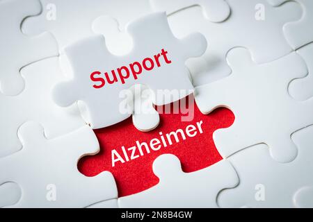 alzheimer's disease, Puzzle with exposed words Support and alzheimer, Concept, Help and support for elderly people struggling with progressive neurode Stock Photo