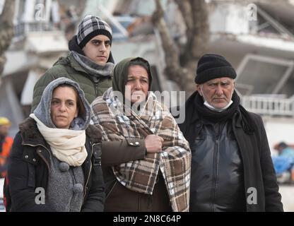 Antakya, Turkey. 11th Feb, 2023. Relatives and neighbors follow the recovery of victims from the rubble of a house. Thousands of victims are still believed to be trapped under the rubble. Teams of helpers from all over the world are working in the disaster area. Credit: Boris Roessler/dpa/Alamy Live News Stock Photo