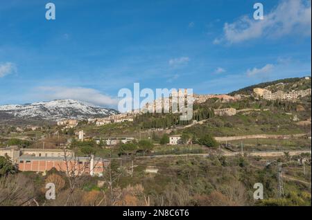 View of Petralia Soprana village among the snow-capped peaks of the Madonie, Sicily Stock Photo