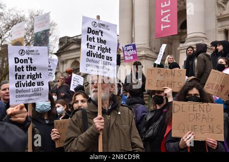 Protesters hold placards during the Trans march.Spectators