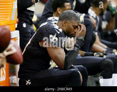 A stunned New Orleans Saints' Roman Harper walks off the field as