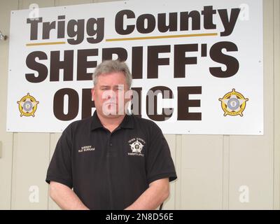 In this Tuesday, Dec. 4, 2012, photo, Trigg County Sheriff Ray Burnam  stands in front of the sheriff's department in Cadiz, Ky. When Burnam  offered $1,000 of his own money as a