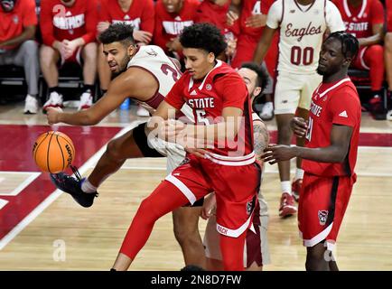 North Carolina State's Jack Clark (5) drives past Austin Peay's Guy  Fauntleroy (10) during the second half of an NCAA college basketball game  in Raleigh, N.C., Monday, Nov. 7, 2022. (Ethan Hyman/The