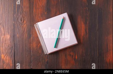 Mockup. An empty A4 notebook with a spiral spring on woode background, top view,flat lay Stock Photo