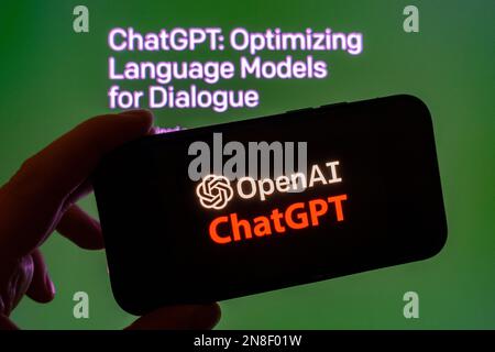 Digital composite of Microsoft ChatGPT OpenAI chatbot logo on phone screen Stock Photo