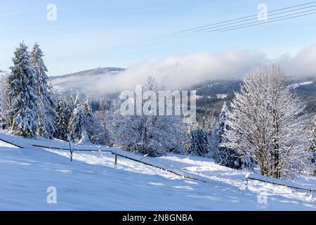 View of ice-covered wooden fence posts on a snowy mountain ridge in ...